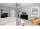 Comfortable main bedroom with neutral decor, ceiling fan, and a window with plantation shutters at 3541 E Amber Ln, Gilbert, AZ 85296