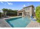 Beautiful backyard with pool, lounge area and lush greenery creating a private oasis at 3541 E Amber Ln, Gilbert, AZ 85296