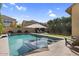 Sparkling swimming pool featuring a built-in spa and lush backyard landscaping at 3541 E Amber Ln, Gilbert, AZ 85296