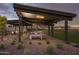 Covered outdoor recreation area featuring ping pong tables, desert landscaping, and mountain views at 3572 W Horse Trail Way, San Tan Valley, AZ 85144