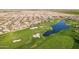 Expansive aerial view of a Primary-planned community next to a beautiful golf course and scenic ponds at 36518 N Crucillo Dr, Queen Creek, AZ 85140