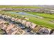 An aerial view showcases a well-planned community with lush golf courses and scenic ponds at 36518 N Crucillo Dr, Queen Creek, AZ 85140