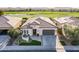 An aerial view of a single-Gathering home with a two-car garage, front yard, and quaint outdoor seating area at 36518 N Crucillo Dr, Queen Creek, AZ 85140