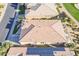 An aerial view captures a home's tile roof, solar panels, and well-maintained landscaping at 36518 N Crucillo Dr, Queen Creek, AZ 85140