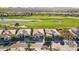 An aerial view shows a neighborhood with well-manicured lawns, landscaping, and a golf course at 36518 N Crucillo Dr, Queen Creek, AZ 85140