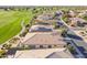 Aerial view displays a golf course community with lush greenery and well-maintained homes at 36518 N Crucillo Dr, Queen Creek, AZ 85140