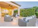 Inviting back patio area featuring a modern fire pit and comfortable wicker seating at 36518 N Crucillo Dr, Queen Creek, AZ 85140