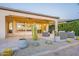 Cozy outdoor patio area complete with a fire pit and desert landscaping at 36518 N Crucillo Dr, Queen Creek, AZ 85140