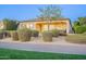 Backyard view showing desert landscaping, mature trees, and a manicured garden, enhancing the property's appeal at 36518 N Crucillo Dr, Queen Creek, AZ 85140