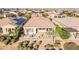 Backyard aerial view featuring landscaping, a paved patio, and outdoor seating surrounded by other homes at 36518 N Crucillo Dr, Queen Creek, AZ 85140