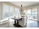 Bright dining area with a modern chandelier and lots of natural light at 36518 N Crucillo Dr, Queen Creek, AZ 85140