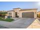 Elegant home exterior featuring a well-maintained yard, landscaping, and a spacious two-car garage at 36518 N Crucillo Dr, Queen Creek, AZ 85140