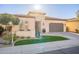 Charming home exterior with a well-manicured lawn, planters, and a two-car garage in a sunny neighborhood at 36518 N Crucillo Dr, Queen Creek, AZ 85140