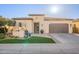 Inviting home exterior with a well-manicured lawn, decorative planters, and a convenient two-car garage at 36518 N Crucillo Dr, Queen Creek, AZ 85140