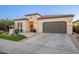 Inviting single-story home with desert landscaping, neutral stucco, and a two-car garage at 36518 N Crucillo Dr, Queen Creek, AZ 85140