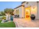 Well-designed home exterior with desert plants, seating area, arched windows, and illuminated entrance at 36518 N Crucillo Dr, Queen Creek, AZ 85140