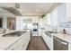 A bright kitchen with white cabinets, stainless steel appliances, and tile backsplash at 36518 N Crucillo Dr, Queen Creek, AZ 85140