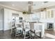 A modern white kitchen features a large island, stainless steel appliances, and a beverage cooler at 36518 N Crucillo Dr, Queen Creek, AZ 85140