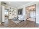 Elegant living room with built-in bookshelves, stylish decor, and a view of the foyer at 36518 N Crucillo Dr, Queen Creek, AZ 85140