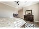 Spacious main bedroom with a ceiling fan, wood-look tile flooring, and lots of natural light at 36518 N Crucillo Dr, Queen Creek, AZ 85140