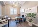 Stylish home office with a modern chandelier, artwork, a glass desk, and comfortable seating at 36518 N Crucillo Dr, Queen Creek, AZ 85140