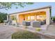 Outdoor patio showcasing desert landscaping, a cozy seating area with a fire pit, and sliding glass doors at 36518 N Crucillo Dr, Queen Creek, AZ 85140