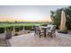 Outdoor dining area showcasing a table with seating, a retractable umbrella, and views of a golf course at 36518 N Crucillo Dr, Queen Creek, AZ 85140