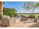 Relax on the patio near the stone fireplace and enjoy golf course views at 36518 N Crucillo Dr, Queen Creek, AZ 85140