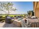 Outdoor patio features a cozy seating area and beautiful golf course views at 36518 N Crucillo Dr, Queen Creek, AZ 85140