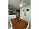 Dining area with a wooden table, ceiling fan, and view into adjacent rooms and kitchen at 36610 W Picasso St, Maricopa, AZ 85138