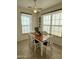 Cozy dining room with modern ceiling fan and natural light from large windows at 36610 W Picasso St, Maricopa, AZ 85138