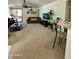 Open living room with large sofa, ceiling fan, and sliding glass door to covered patio at 36610 W Picasso St, Maricopa, AZ 85138