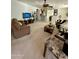 Open concept living room with view to kitchen, ceiling fan, and neutral tones at 36610 W Picasso St, Maricopa, AZ 85138