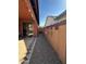 View of side yard with gravel and covered patio area at 36610 W Picasso St, Maricopa, AZ 85138