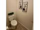 Powder room featuring neutral colors, tile flooring, and elegant wall art for a calming atmosphere at 36610 W Picasso St, Maricopa, AZ 85138