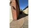 Outdoor walkway featuring a brick-paved path leading to a backyard gate in a home at 36610 W Picasso St, Maricopa, AZ 85138