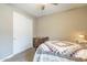 Cozy bedroom with neutral walls, carpet flooring, and a closet with white sliding doors at 38101 W Santa Maria St, Maricopa, AZ 85138