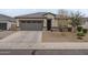 Charming single-story home featuring a grey garage door, neutral stucco, and well-maintained front yard landscaping at 38101 W Santa Maria St, Maricopa, AZ 85138