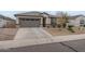 Charming single-story home featuring a grey garage door, neutral stucco, and well-maintained front yard landscaping at 38101 W Santa Maria St, Maricopa, AZ 85138