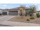 Charming single-story home featuring a grey garage door, neutral stucco, and well-maintained front yard landscaping at 38101 W Santa Maria St, Maricopa, AZ 85138