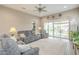 Comfortable living room with sliding glass doors, neutral walls, and a plush grey sofa set at 38101 W Santa Maria St, Maricopa, AZ 85138