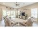 Inviting living room featuring neutral walls, plush grey sofas, and sliding glass doors leading to outdoor space at 38101 W Santa Maria St, Maricopa, AZ 85138