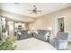 Cozy living room featuring neutral walls, plush grey sofas, and an open layout leading into the kitchen at 38101 W Santa Maria St, Maricopa, AZ 85138