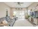 Comfortable living room with sliding glass doors, neutral walls, and a plush grey sofa set at 38101 W Santa Maria St, Maricopa, AZ 85138