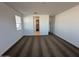 This carpeted bedroom with multiple windows offers abundant natural light and neutral decor at 38150 W Bello Ln, Maricopa, AZ 85138