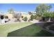 Backyard featuring a verdant lawn, manicured landscape and mature shade trees and desert plants at 4002 E Rockwood Dr, Phoenix, AZ 85050