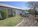 Landscaped backyard featuring a manicured lawn, gravel and a quaint greenhouse at 4002 E Rockwood Dr, Phoenix, AZ 85050