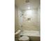 Beautiful bathroom with marble tiled walls, tub and golden fixtures and a built in shower niche at 4002 E Rockwood Dr, Phoenix, AZ 85050