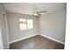 Bright bedroom with a modern ceiling fan, wood-look flooring, and a view of the private backyard at 4002 E Rockwood Dr, Phoenix, AZ 85050