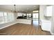 Bright dining area with views of the kitchen featuring wood floors, and modern chandelier-style lighting at 4002 E Rockwood Dr, Phoenix, AZ 85050